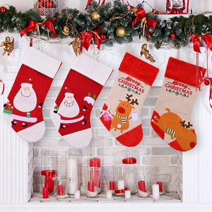 Festive 4-pack Christmas stockings featuring Santa and reindeer designs on a mantel