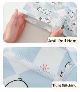 Detail of boys' cotton boxer briefs showing anti-roll leg hems and precise stitching seams