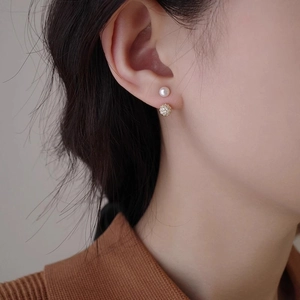 Elegant minimalist pearl and gold pave ball stud earrings on model for a chic daily style