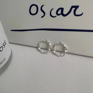 Detail showing S925 hallmark on the inner band of silver Mobius twisted hoop earrings