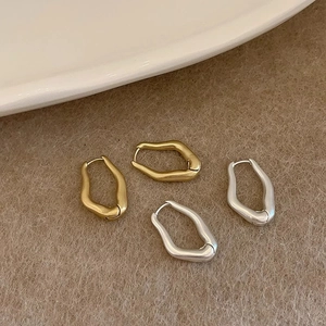 Irregular geometric wave hoop earrings in gold and silver matte metal finish