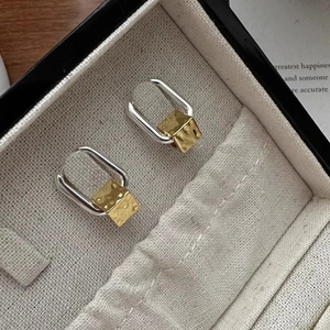 Minimalist square geometric earrings in gold and silver mixed metal finish on jewelry box