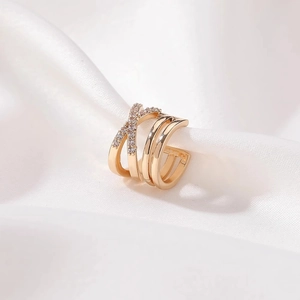 Gold-plated layered zircon ear cuff with crisscross design on white silk background