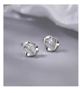 Detailed view of silver S925 Mobius stud earrings with sparkling round zircon accents