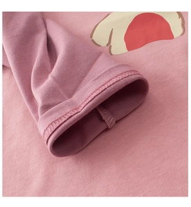 Close-up of pink long-sleeve cotton T-shirt featuring neat stitching and cartoon print