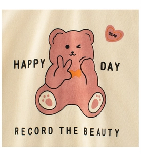 Close-up of beige knit fabric featuring a cute pink cartoon bear print with heart logo