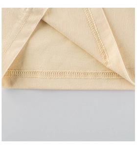 Close-up of high-quality double-needle stitching on beige cotton kids long sleeve T-shirt
