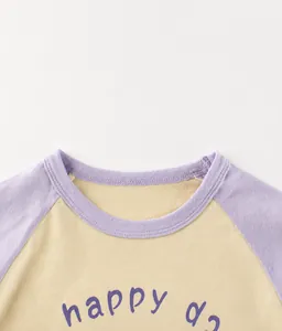 Close-up of crew neck stitching on raglan cotton t-shirt with happy print