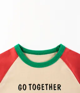 Detail of the green ribbed neckline and 'GO TOGETHER' printed text on children's shirt