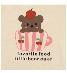 Close-up of cute cartoon bear and cupcake print on beige cotton t-shirt fabric