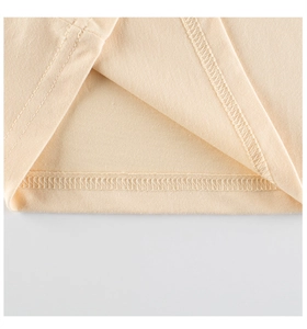 Close-up of double-needle stitching on beige knitted girls' t-shirt hem and fine texture
