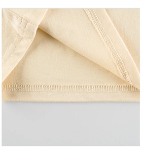 Detailed close-up of double-stitched hem and fine knit texture on beige cotton shirt