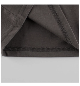 Close-up of double-needle stitching and fine cotton texture on dark grey long-sleeve tee