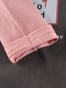 Girls long sleeve t-shirt featuring pink sleeves and grey cotton fabric close-up