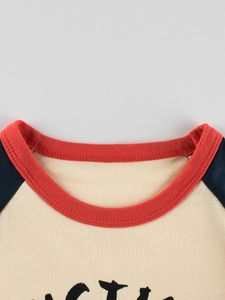 Girl's long sleeve raglan t-shirt with red ribbed crew neck and navy blue sleeves