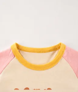 Detail showing the ribbed yellow neckline and pink sleeves of a cotton kids t-shirt