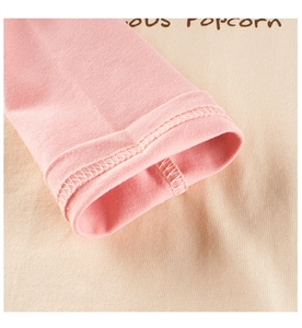 Detail of pink and beige contrast sleeves with premium double-needle stitching on cuff