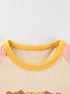 Kids round neck T-shirt with yellow ribbed neckline and pink raglan sleeves