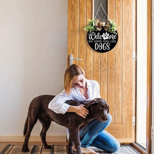 Close-up of wooden Welcome sign for dog lovers with greenery and black white bow