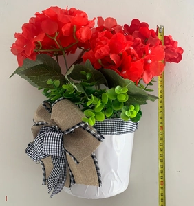 Measurement of red artificial geranium hanging basket height showing 31cm on tape measure
