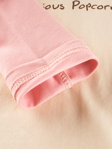 Close-up of pink long sleeves and beige knit cotton T-shirt with Popcorn print