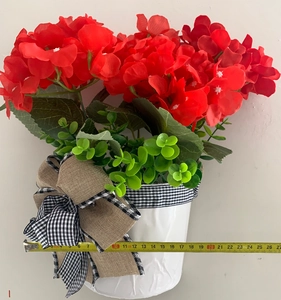 Detail view of red hydrangea hanging basket with bow decoration and 26cm width measurement