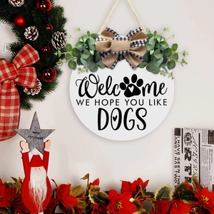 Detail of wooden welcome sign featuring eucalyptus, plaid bow, and dog lover message