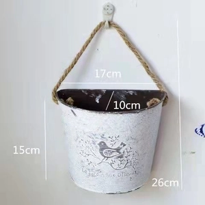 Detailed dimensions of a vintage metal wall planter bucket with bird motif and rope handle