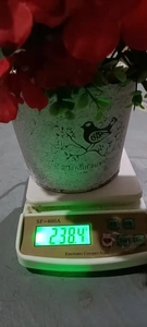 Weight measurement of red artificial geranium hanging basket in vintage grey planter
