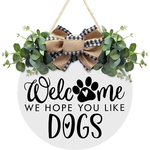 White wooden welcome wreath sign for front door with eucalyptus and dog paw design