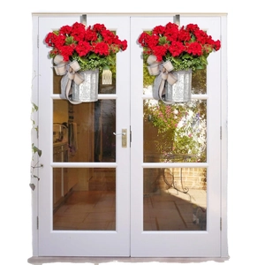 Artificial Christmas hanging baskets with red geraniums and black white checkered bows