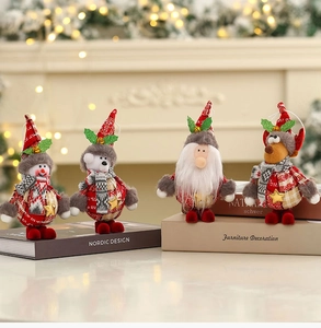 Close-up of four plush Christmas ornaments including snowman and reindeer figurines