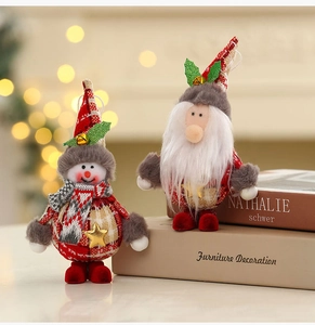 Close-up of plush snowman and Santa ornaments with sequins and striped knit textures