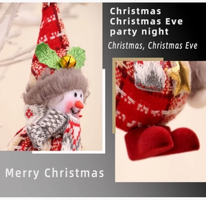 Detail of red and white plaid Christmas snowman doll with bells and star ornaments
