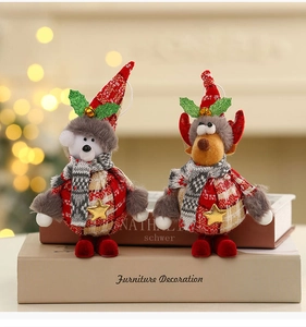 Detail of Christmas reindeer and bear plush figurines with red hats and gold stars