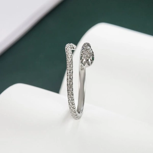 Silver snake ring with green stone eyes and sparkling cubic zirconia head detailing