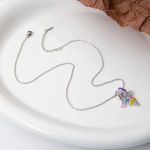 Close-up of a silver chain necklace with colorful enamel charms and adjustable lobster clasp