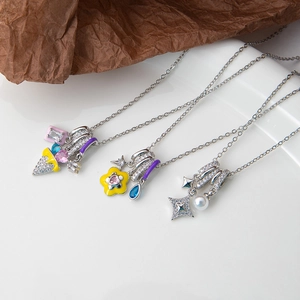 Detailed close-up of enamel pendants with colorful cubic zirconia and a white pearl