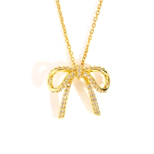 Detailed view of a gold bow pendant necklace with sparkling zircon pavé on O-chain