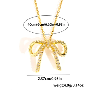 Detail view of gold bow necklace with dimensions 40+6cm chain and 2.37cm pendant width