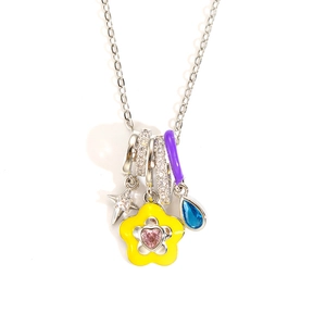 Detailed macro shot of enamel flower and star charms on a colorful zircon necklace