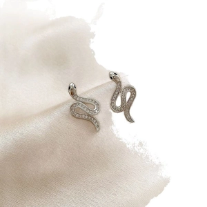 Elegant silver snake stud earrings with shimmering rhinestones on silk and faux fur