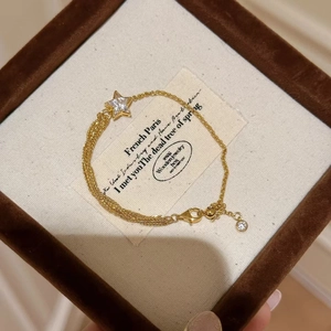 Elegant gold comet star bracelet with cubic zirconia in a premium velvet gift box