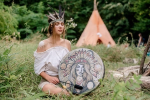 Artistic shamanic hand drum featuring indigenous woman portrait in a forest scene