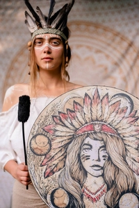 Detail of Shamanic frame drum with Indian feather headdress portrait and drumstick