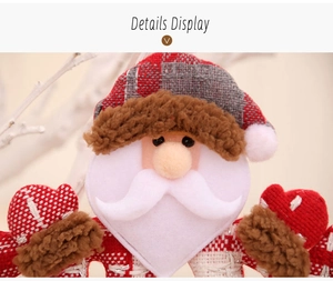 Detailed close-up of plush Santa Claus ornament with red plaid hat and soft faux fur textures