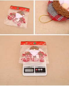 Detail of Santa Claus and JOY letter ornament with red plaid fabric and golden hanging cord