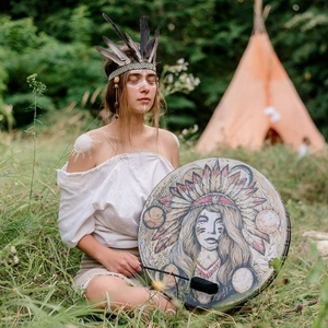 Handcrafted shamanic drum with tribal illustration featuring a wooden frame and mallet