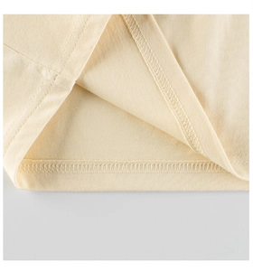 Detail of double-needle stitched hem and soft cotton fabric on girls long sleeve tee