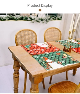 Detail of Christmas placemats with Santa Claus and snowman motifs on a wooden table
